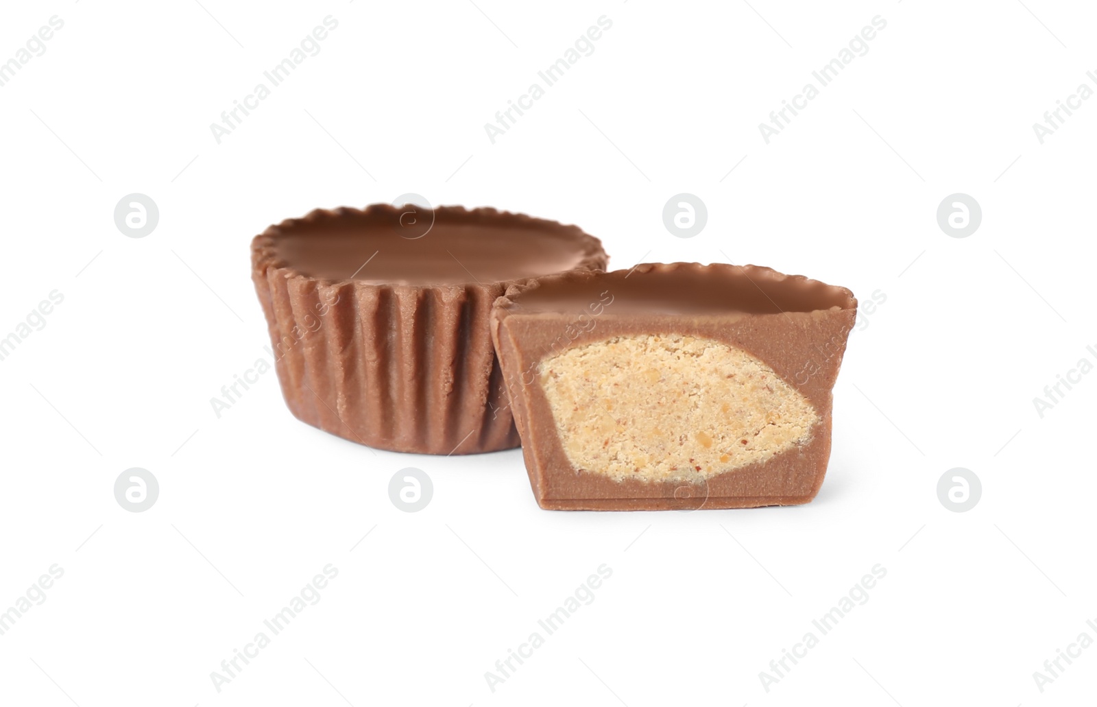 Photo of Cut and whole peanut butter cups isolated on white