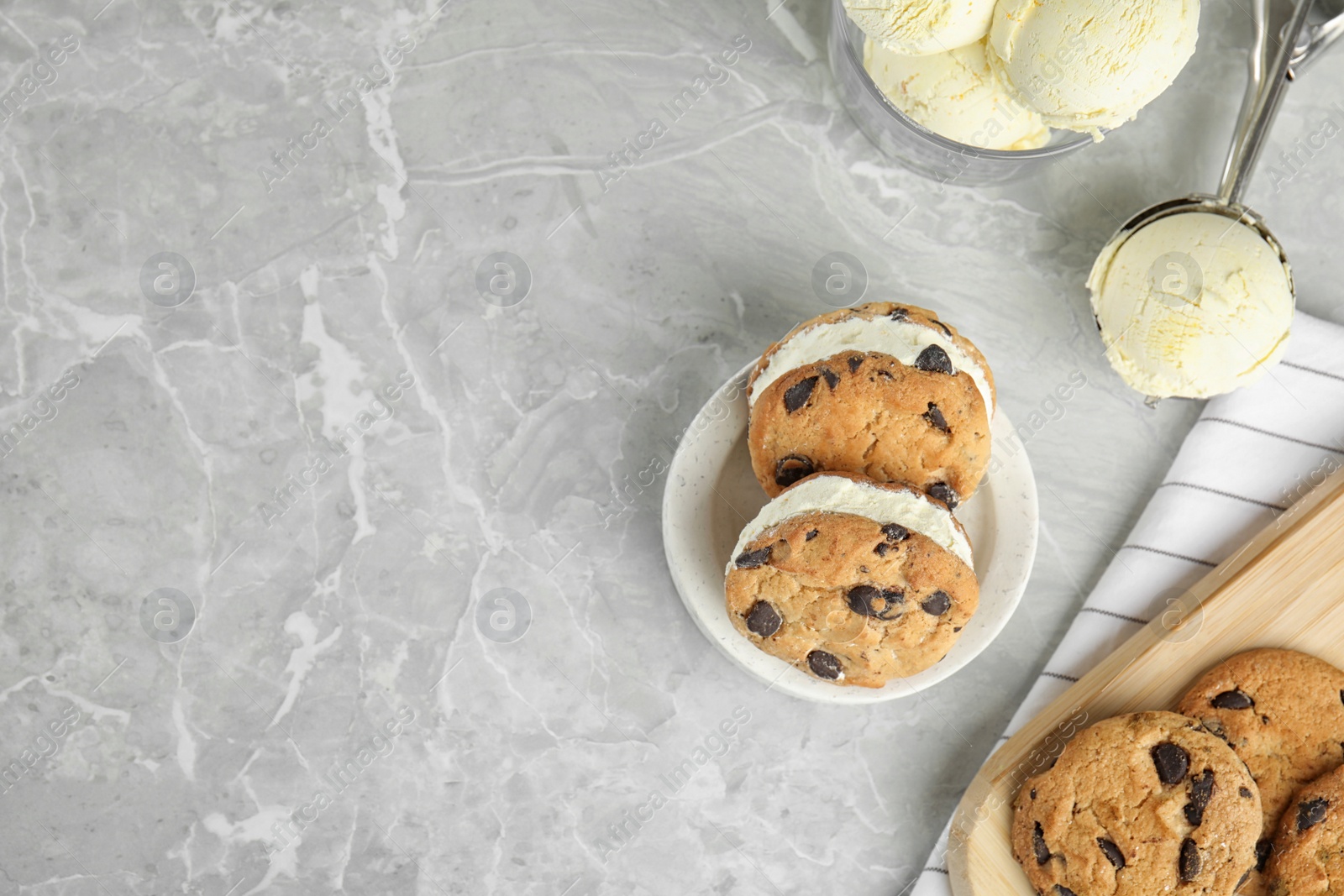 Photo of Sweet delicious ice cream cookie sandwiches served on table, flat lay. Space for text