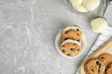 Photo of Sweet delicious ice cream cookie sandwiches served on table, flat lay. Space for text