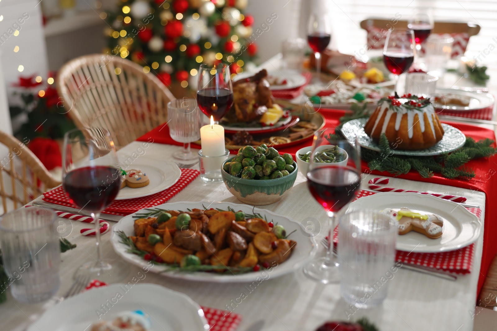 Photo of Festive dinner with delicious food and wine on table indoors. Christmas Eve celebration