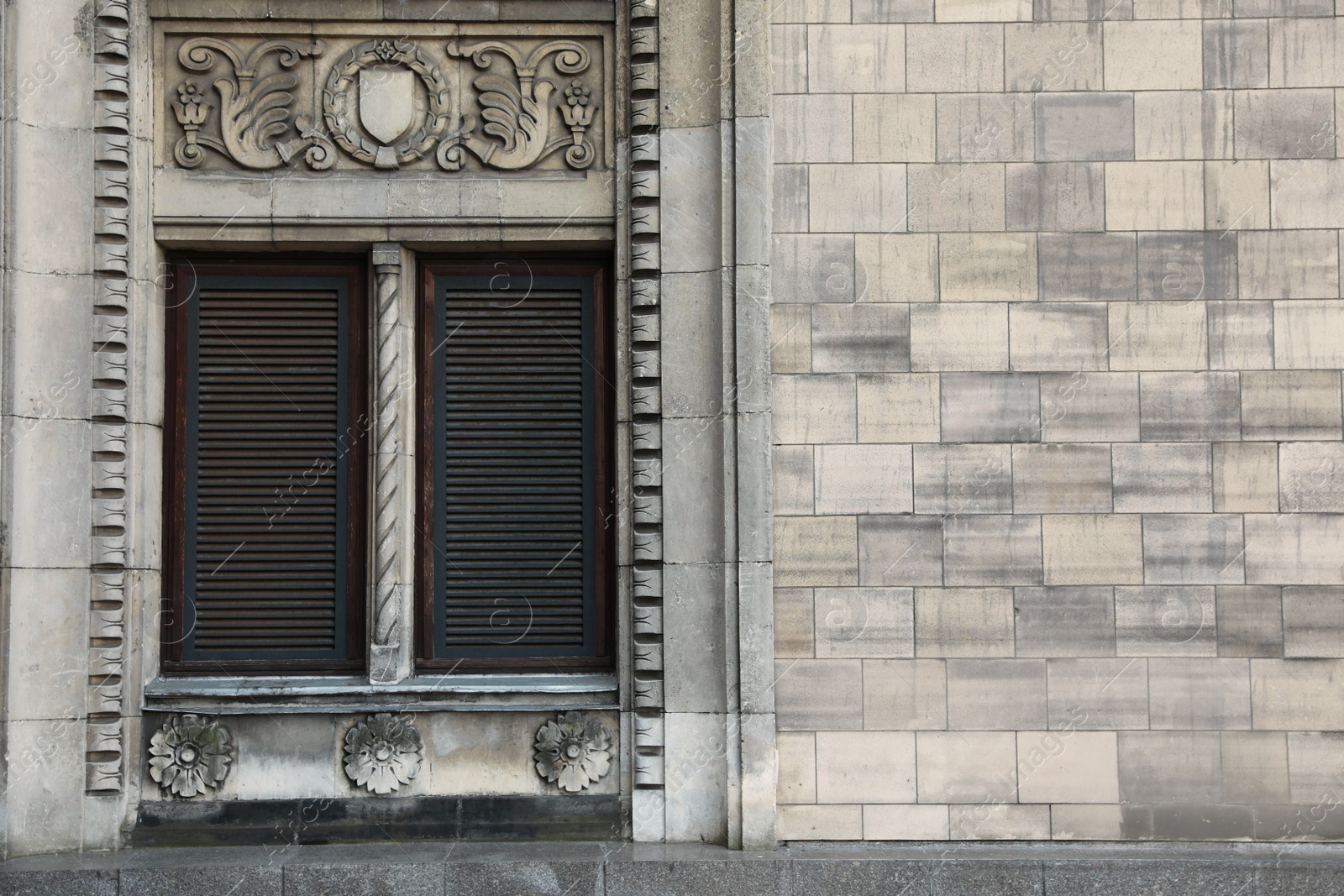 Photo of Window with closed shutters in building outdoors, space for text