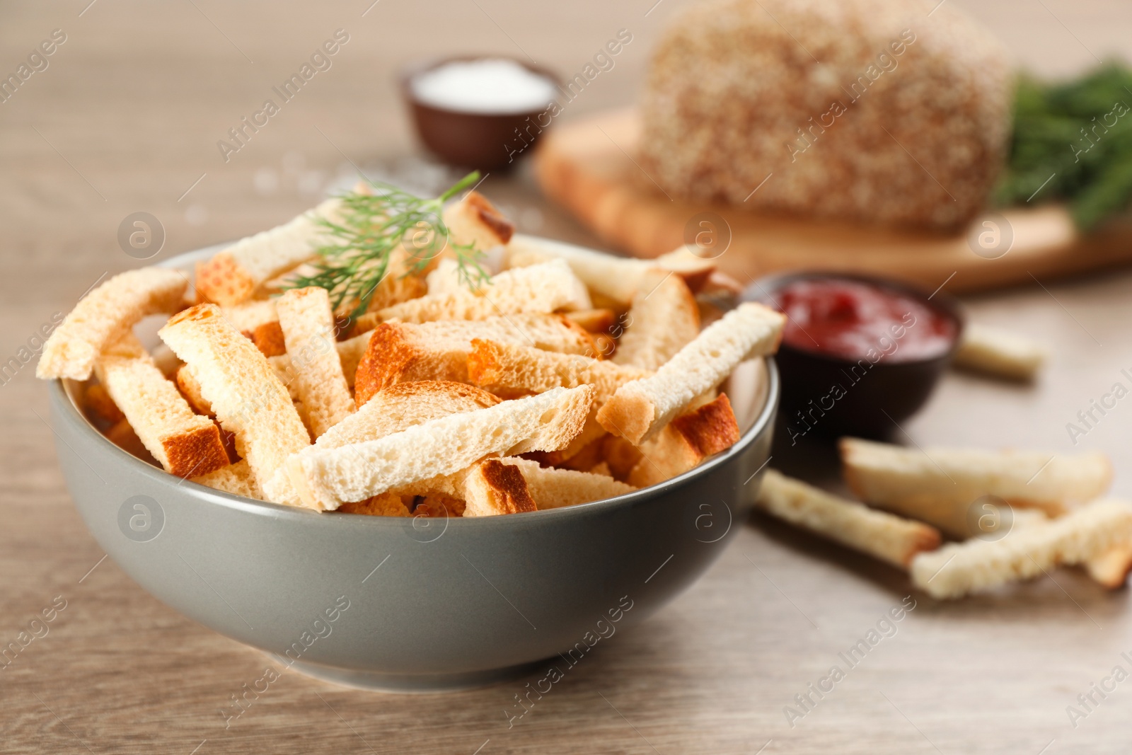 Photo of Delicious hard chucks in bowl on wooden table