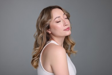 Portrait of beautiful woman on grey background