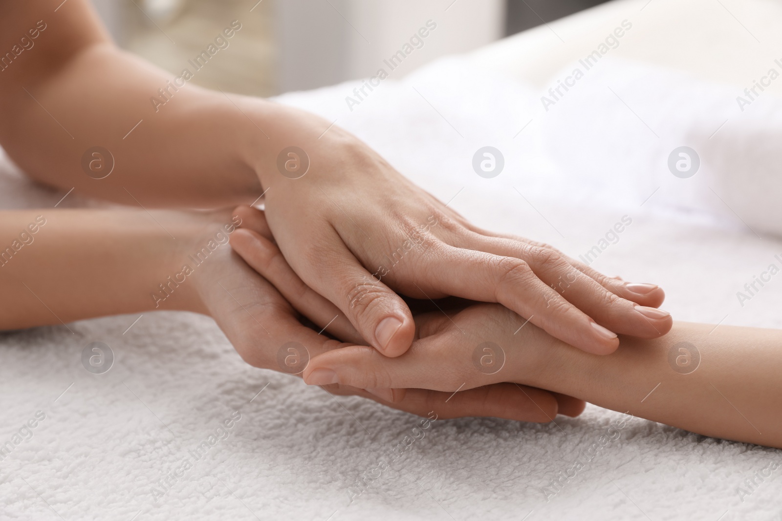 Photo of Woman receiving hand massage in wellness center, closeup