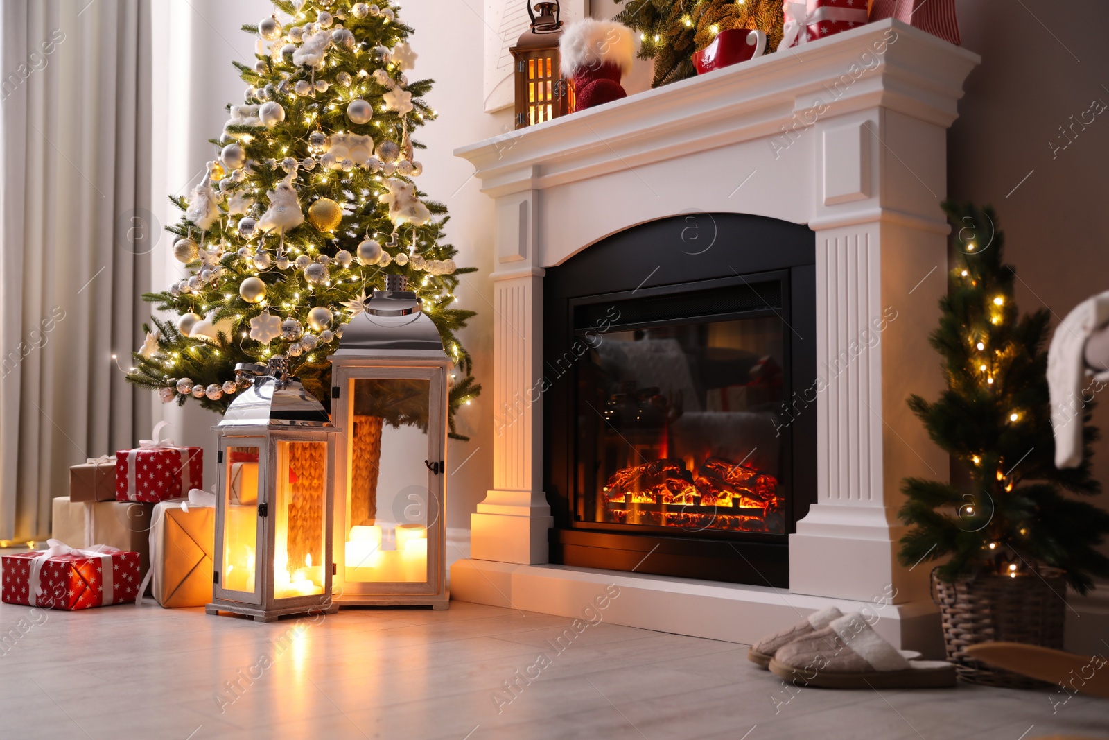 Photo of Beautiful fireplace, Christmas tree and other decorations in living room. Interior design