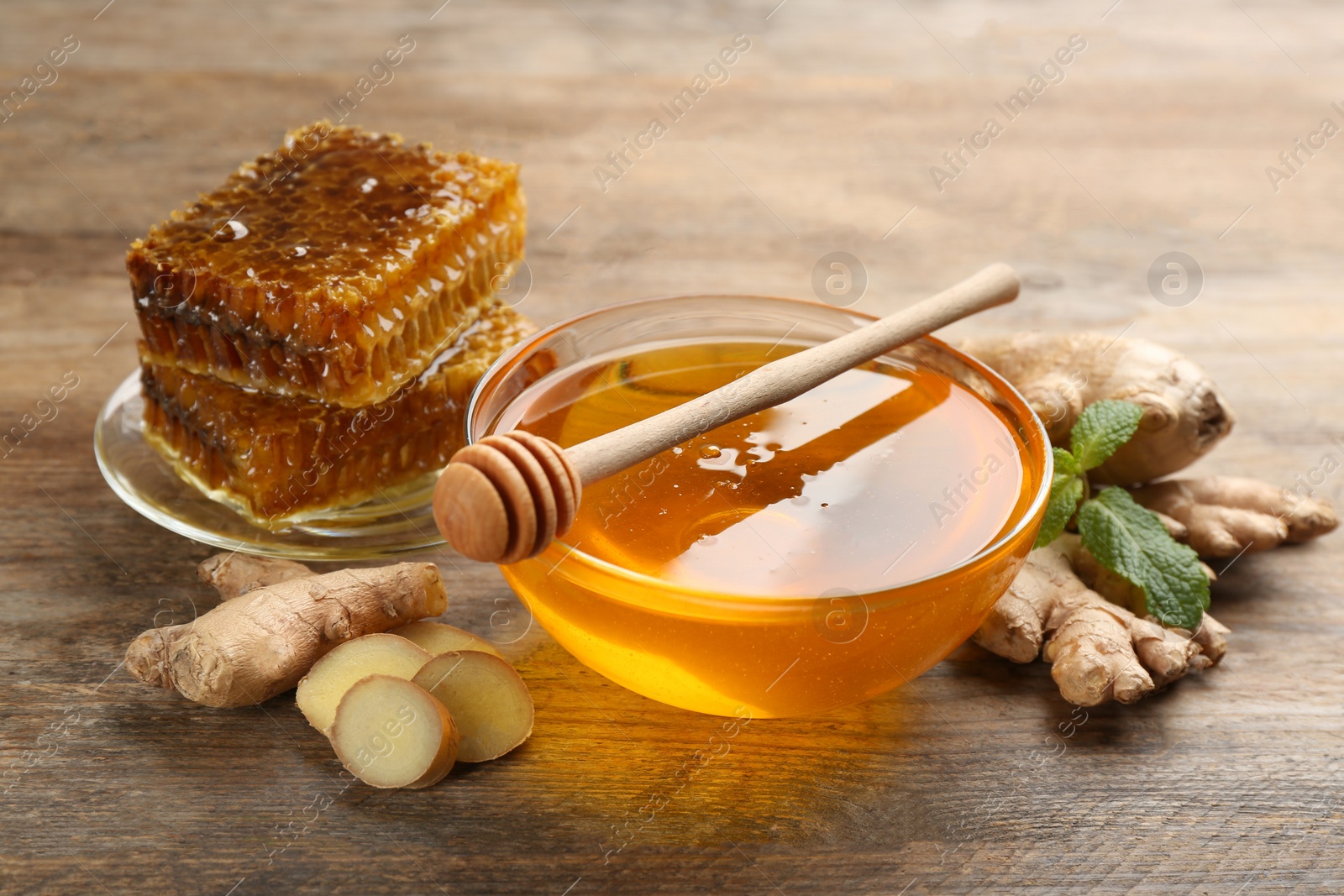 Photo of Honey and ginger on wooden table. Natural cold remedies