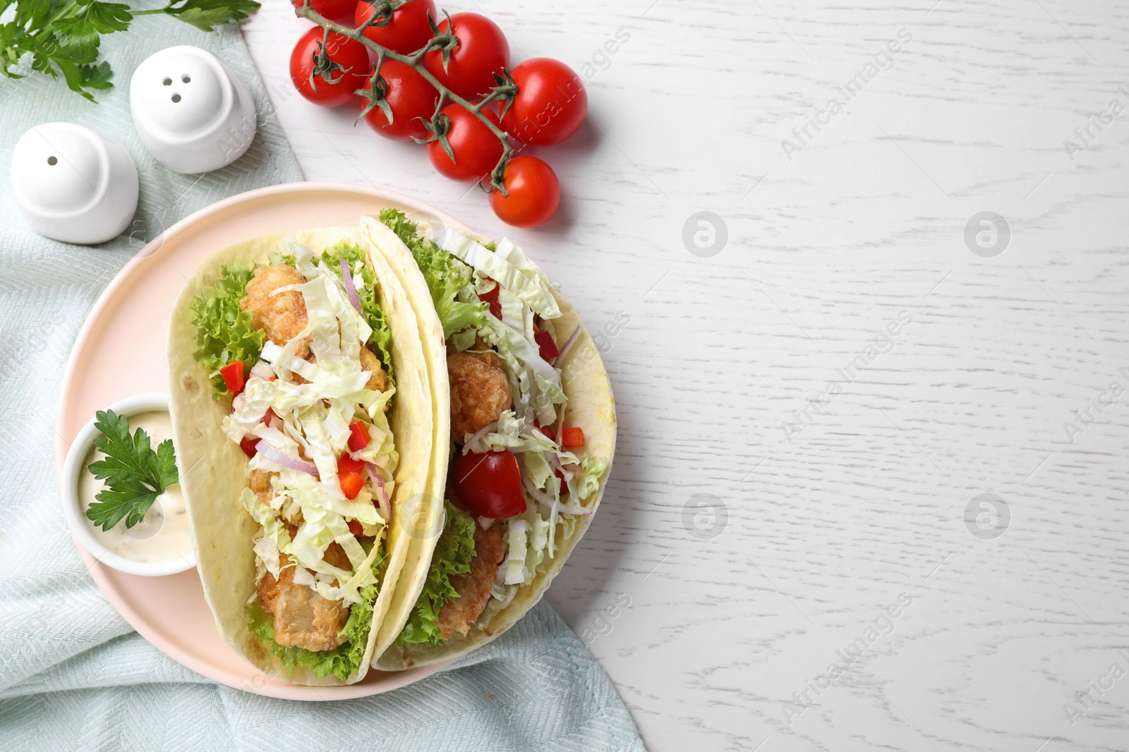 Photo of Yummy fish tacos served on white wooden table, flat lay. Space for text