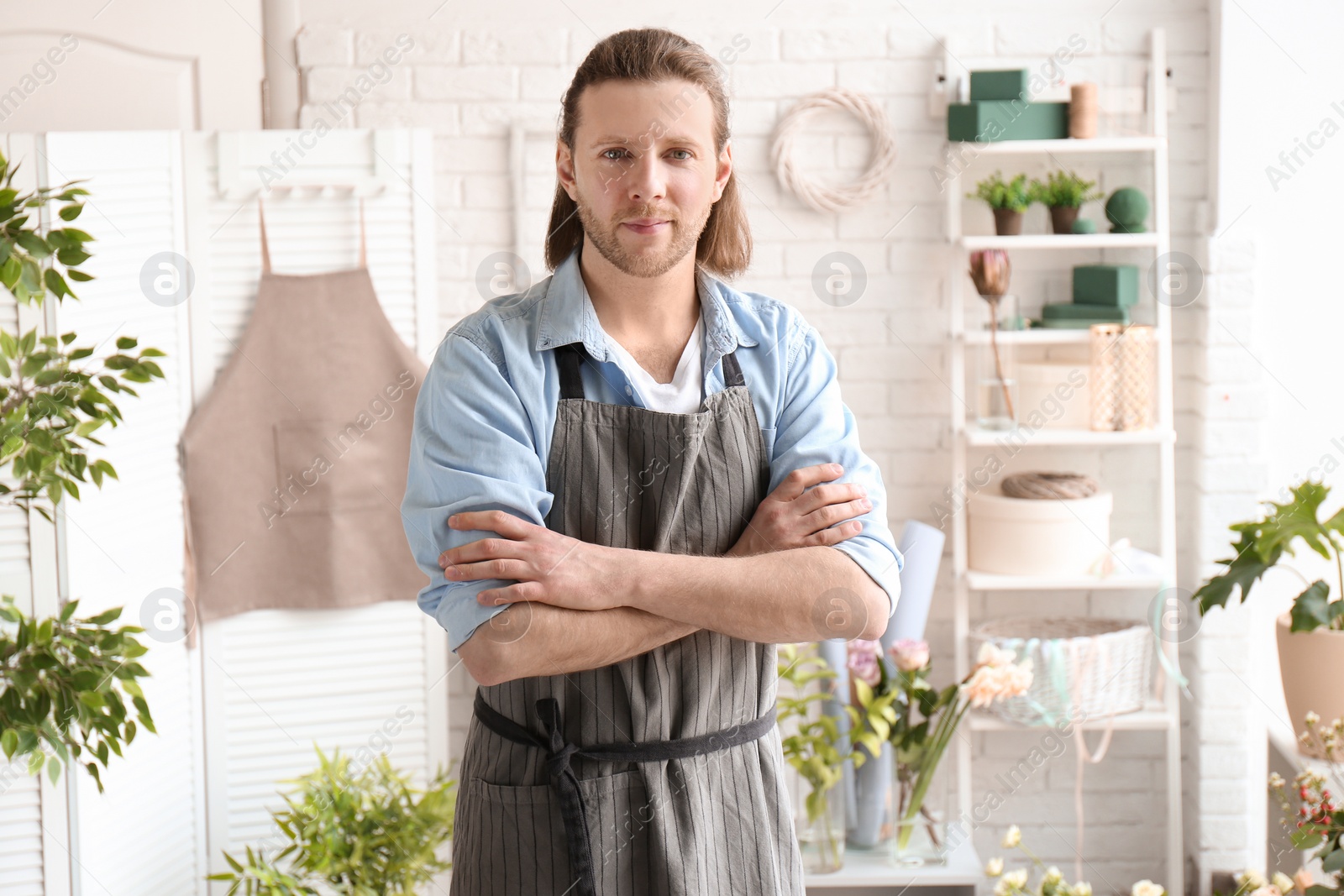 Photo of Portrait of handsome male florist at workplace