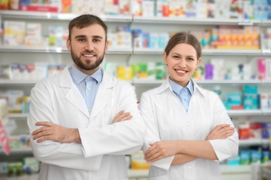 Photo of Portrait of professional pharmacists in modern drugstore