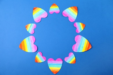 Top view of rainbow hearts on color background, space for text. Gay symbol