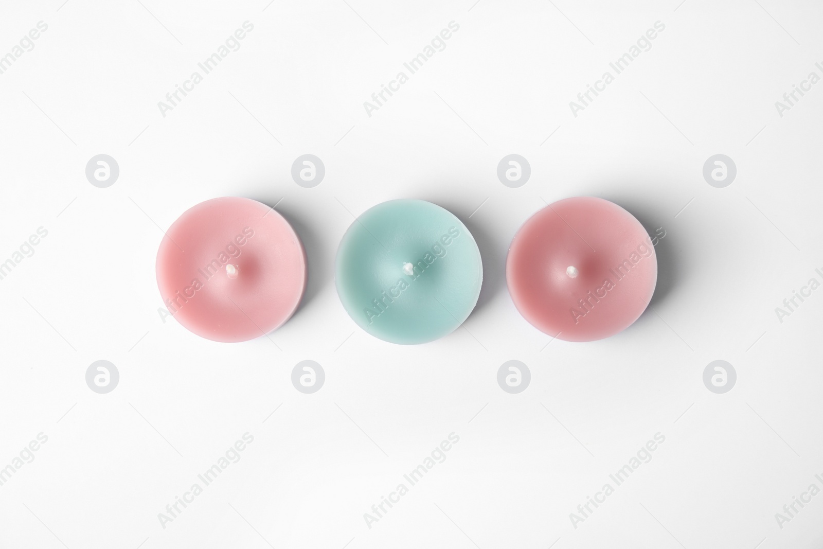 Photo of Color wax decorative candles isolated on white, top view