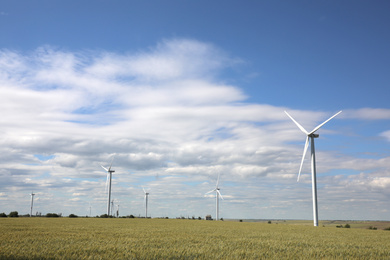 Photo of Beautiful view of field with wind turbines. Alternative energy source