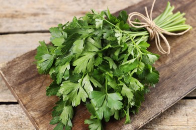 Bunch of fresh green parsley leaves on wooden table, closeup