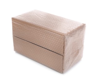 Photo of Cardboard box packed in bubble wrap isolated on white