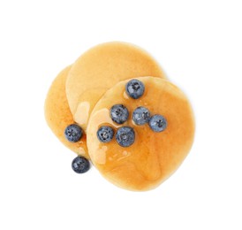 Tasty pancakes with blueberries and honey isolated on white, top view