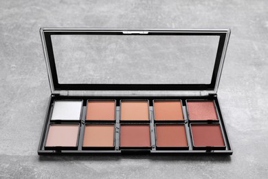Photo of Contouring palette on light gray background. Professional cosmetic product