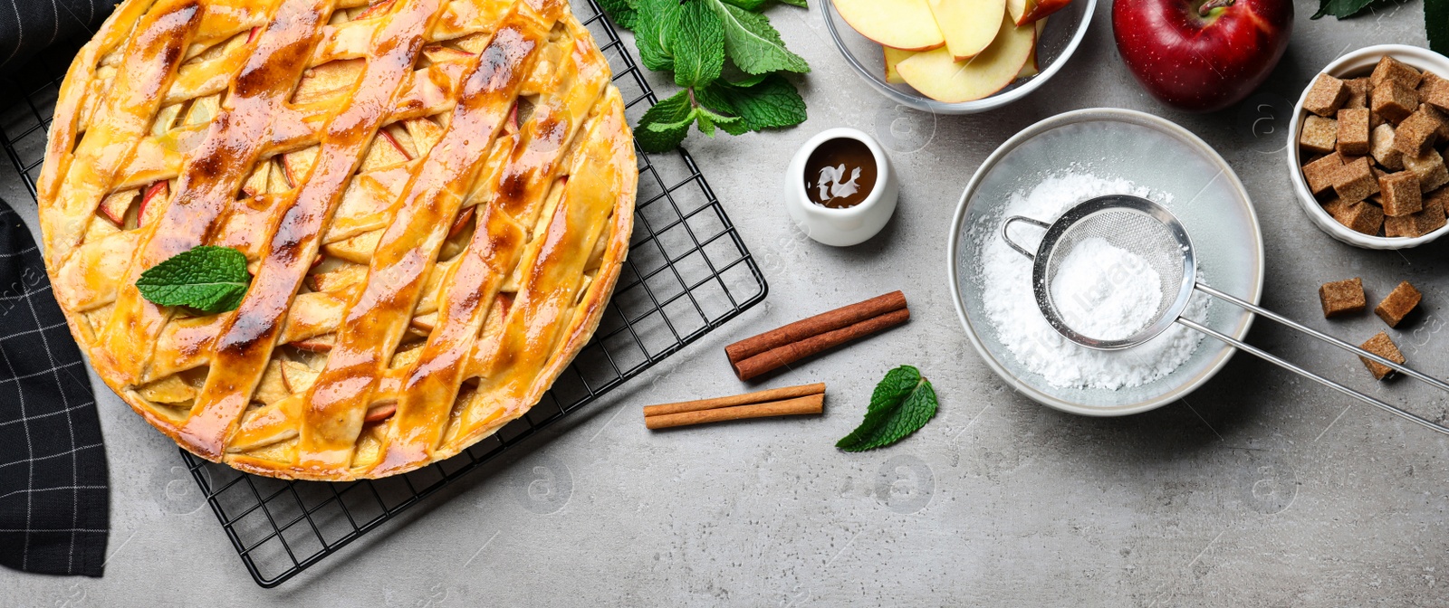 Image of Flat lay composition with fresh traditional apple pie on light grey table. Banner design