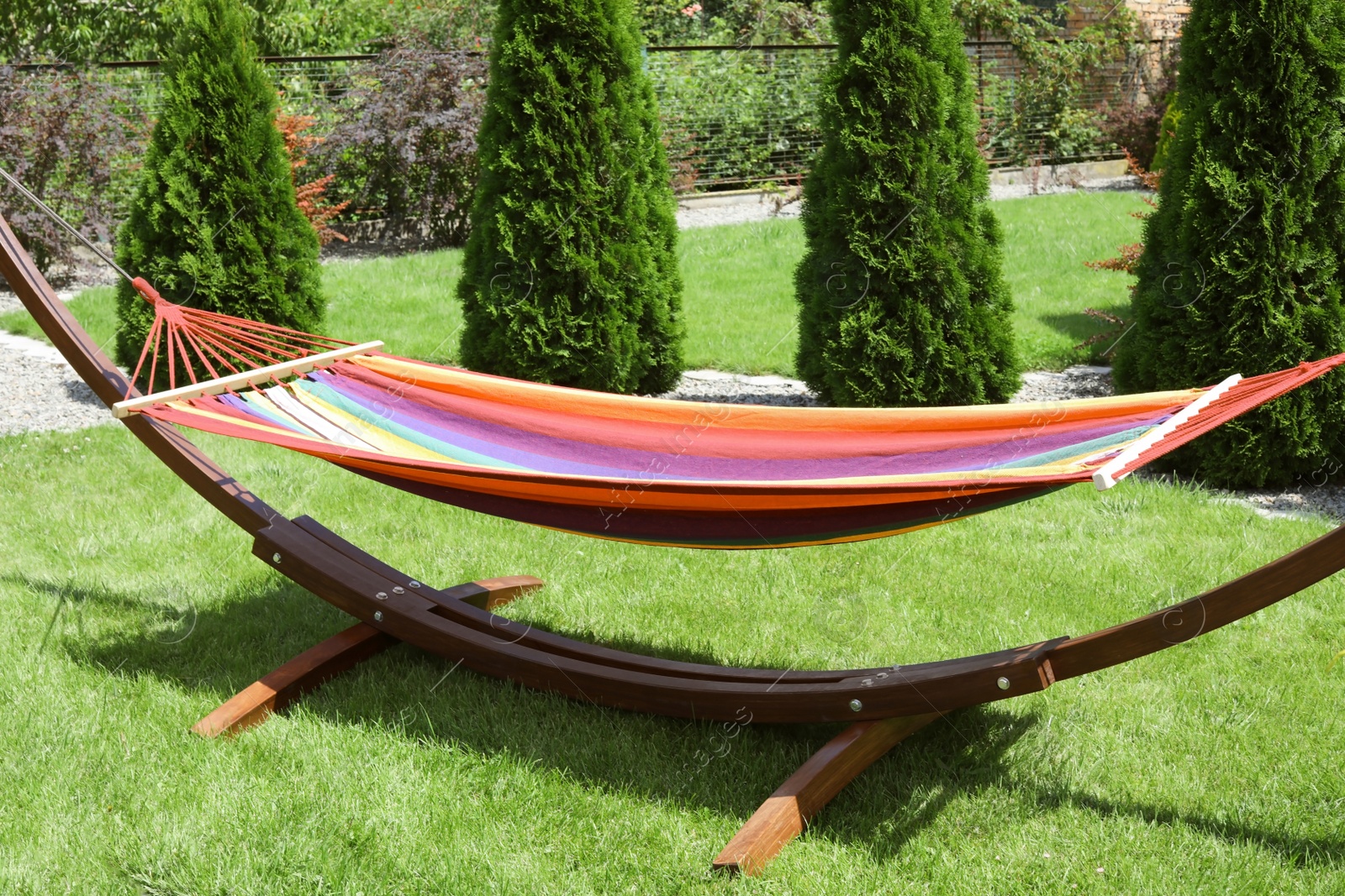 Photo of Empty comfortable hammock outdoors on sunny day