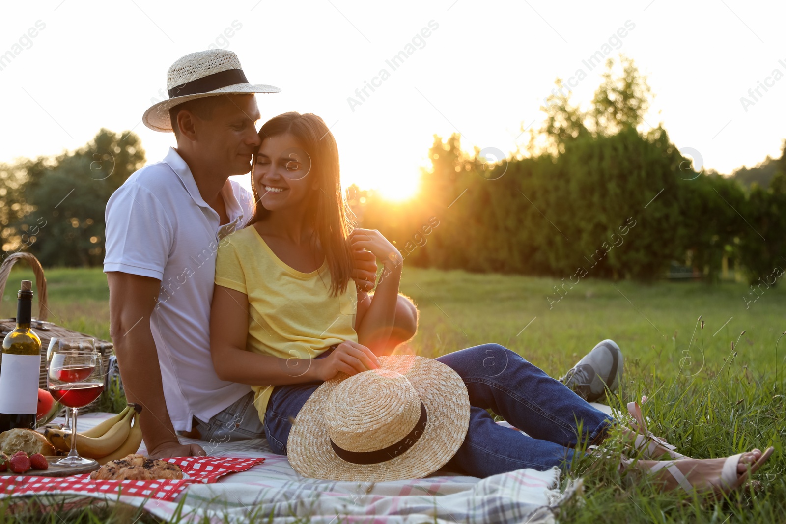 Photo of Happy couple having picnic in park on sunny day