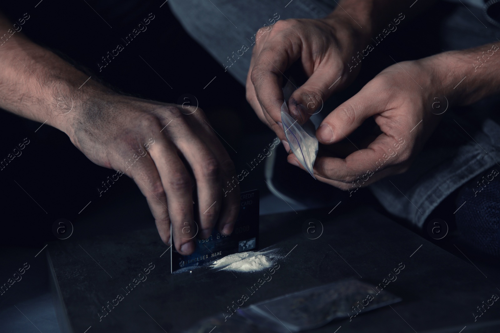 Photo of Young addicted men taking drugs, closeup of hands