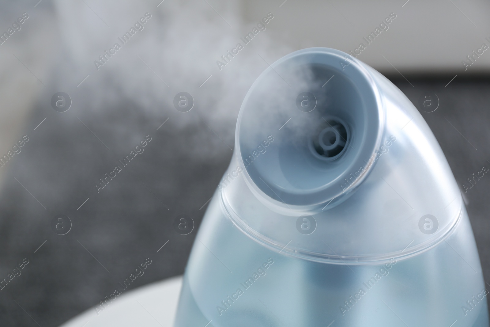 Photo of Modern air humidifier at home, closeup view. Space for text