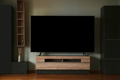 Modern TV set on table in room. Interior design