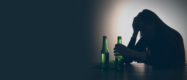 Image of Suffering from hangover. Woman with alcoholic drink at table against black background, space for text. Banner design
