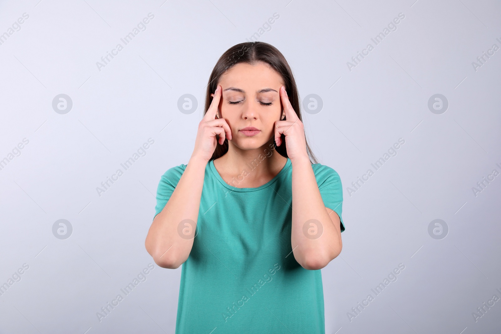 Photo of Portrait of stressed young woman on light background