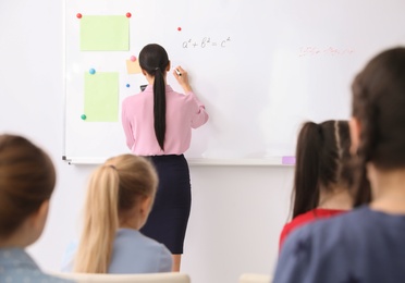 Young teacher and students in modern classroom