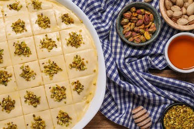 Photo of Making delicious baklava. Raw dough with ingredients on table, flat lay