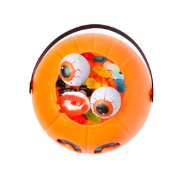 Halloween trick or treat bucket with different sweets on white background, top view