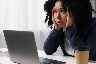 Deadline concept. Stressed woman near laptop in office