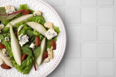 Delicious pear salad on white tiled table, top view. Space for text