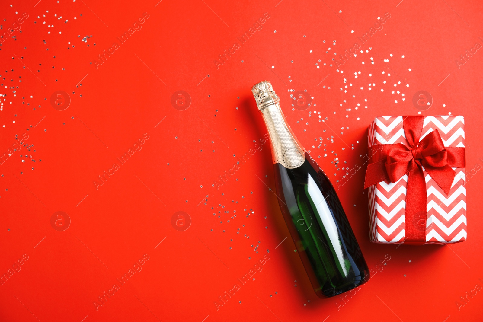 Photo of Creative flat lay composition with bottle of champagne and space for text on color background