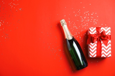 Photo of Creative flat lay composition with bottle of champagne and space for text on color background