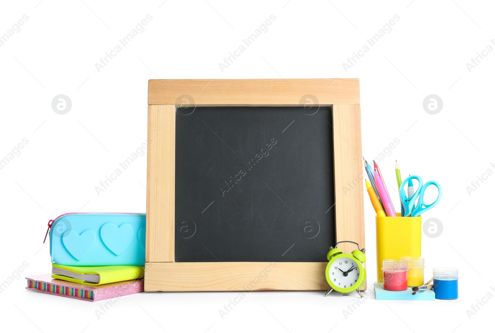 Photo of Different school stationery and small blank chalkboard on white background. Space for text