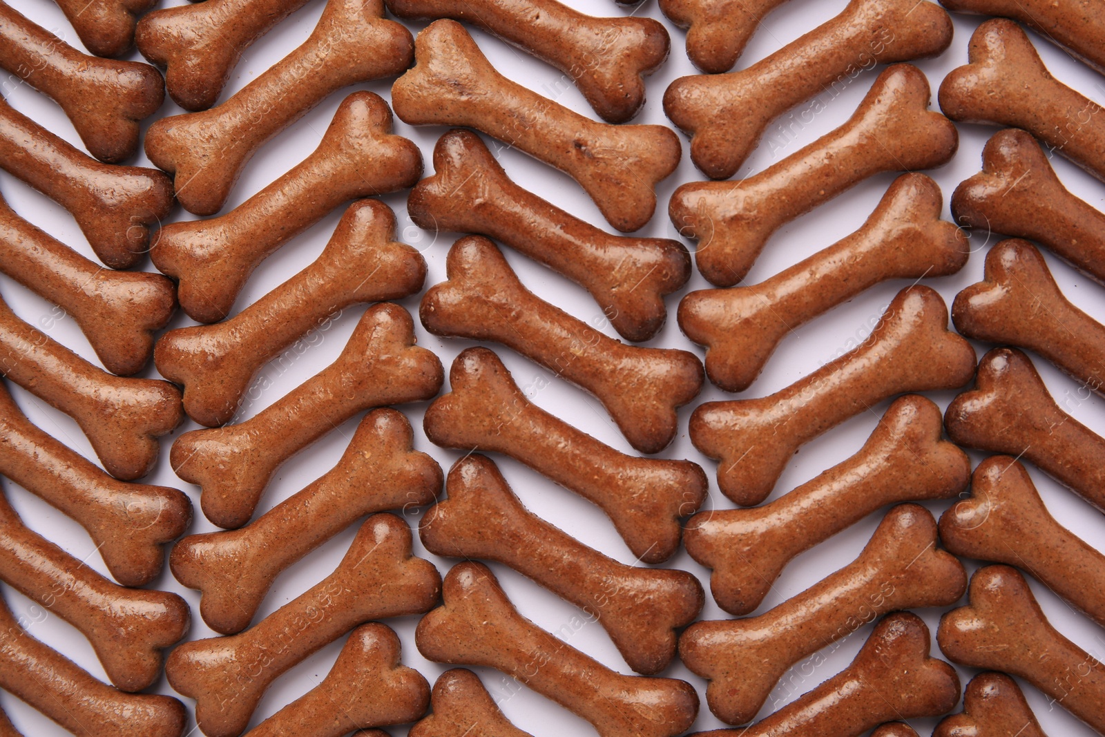Photo of Flat lay composition with many bone shaped dog cookies on white background