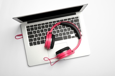 Photo of Modern headphones and laptop on white background, top view