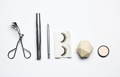 Set of makeup products on white background, top view