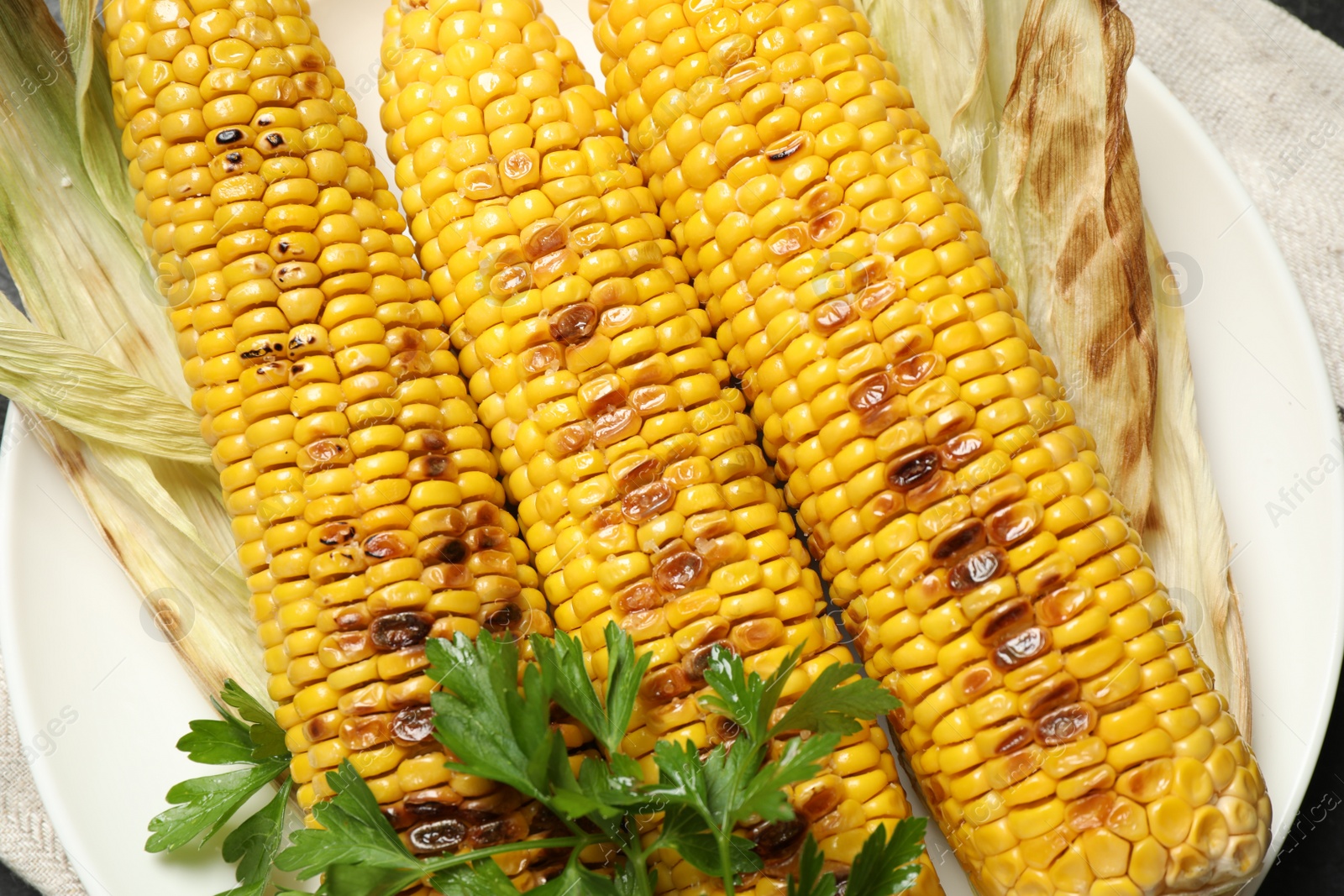 Photo of Top view of tasty grilled corn, closeup