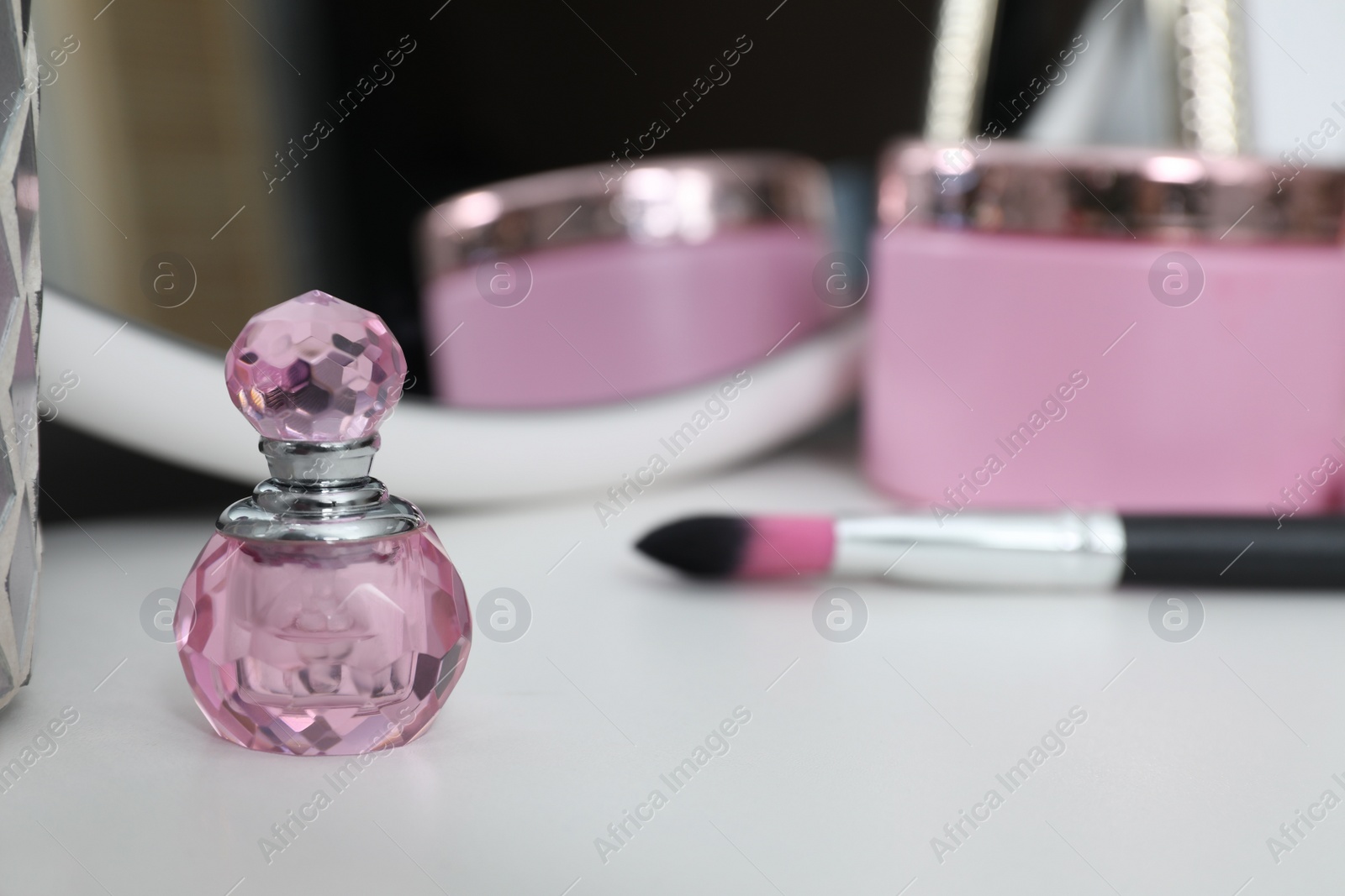 Photo of Stylish dressing table with different cosmetic products and mirror, closeup. Space for text