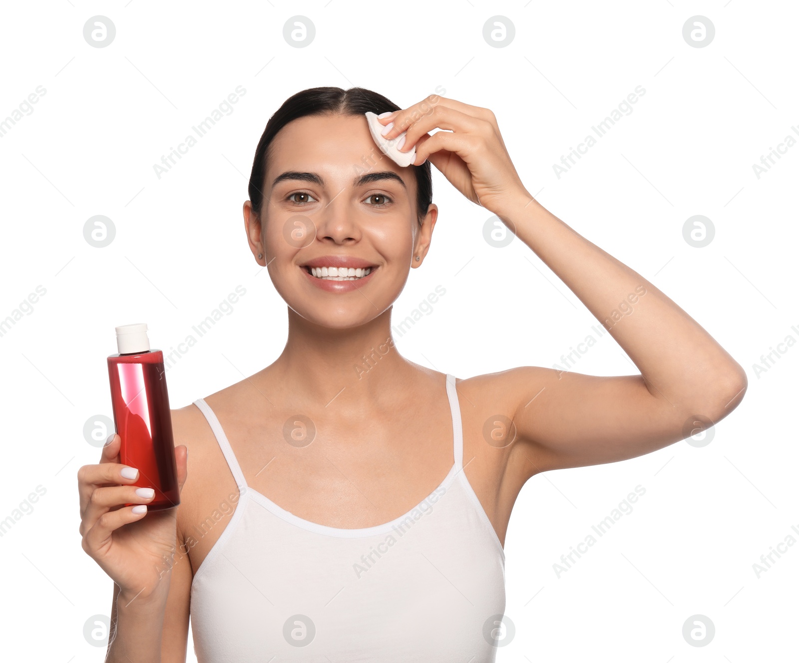 Photo of Young woman using cotton pad with micellar water on white background