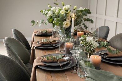 Festive table setting with beautiful floral decor indoors