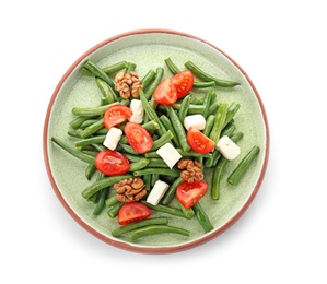 Plate with tasty green beans, nuts, tomatoes and cheese on white background