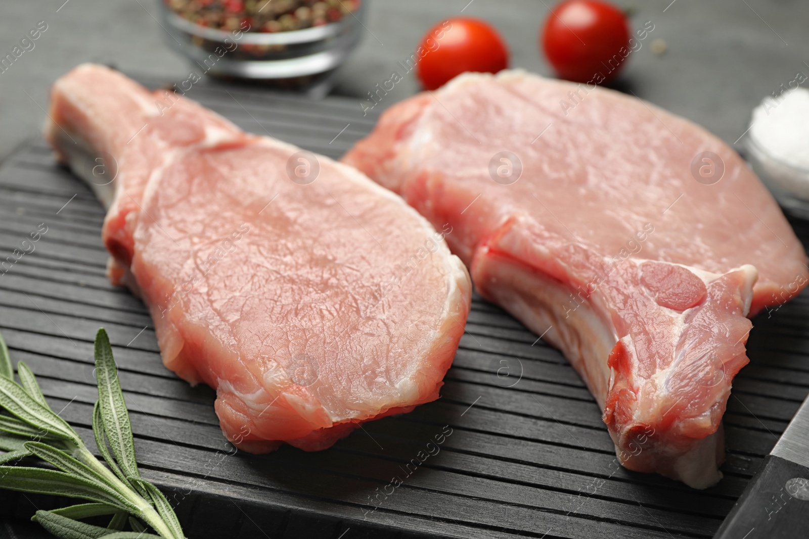 Photo of Board with fresh raw cut meat on table, closeup