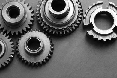 Photo of Different stainless steel gears on grey background, above view. Space for text