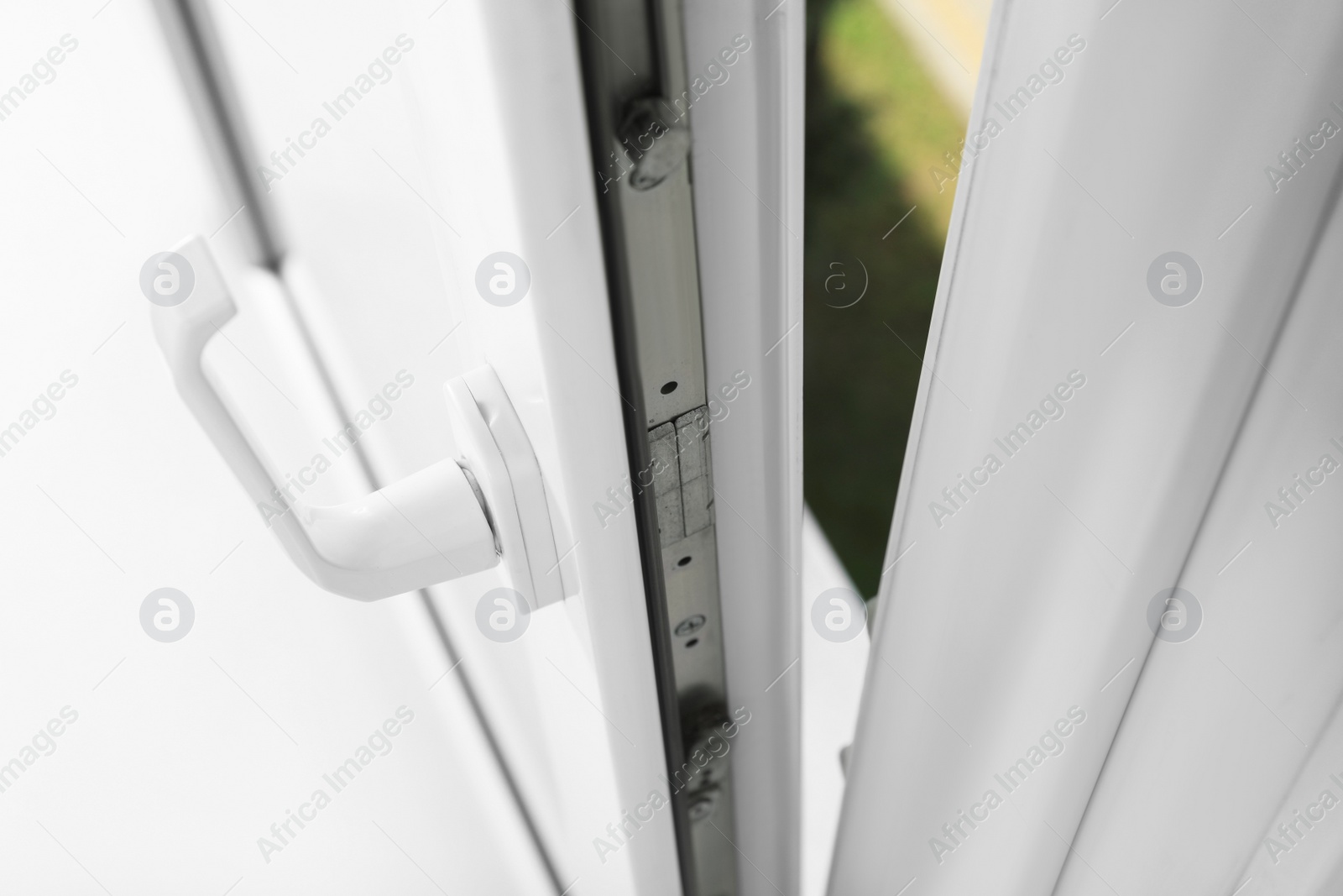 Photo of Above view of open window with white plastic frame indoors, closeup