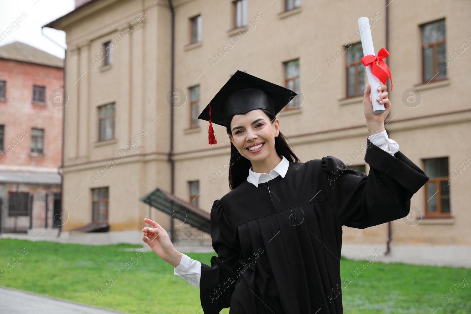 Photo of Happy student with diploma after graduation ceremony outdoors. Space for text