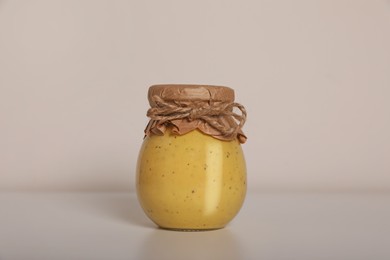 Photo of Jar of tasty pickled sauce on white background