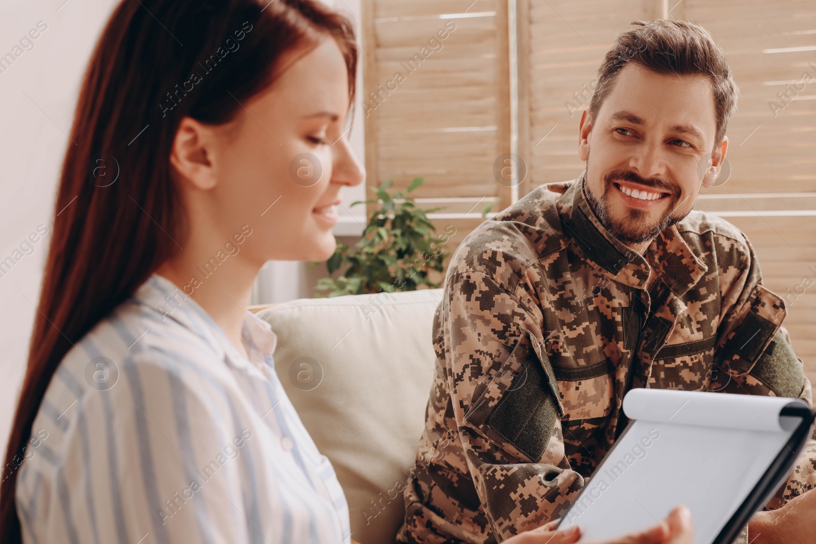 Photo of Psychologist working with military officer in office